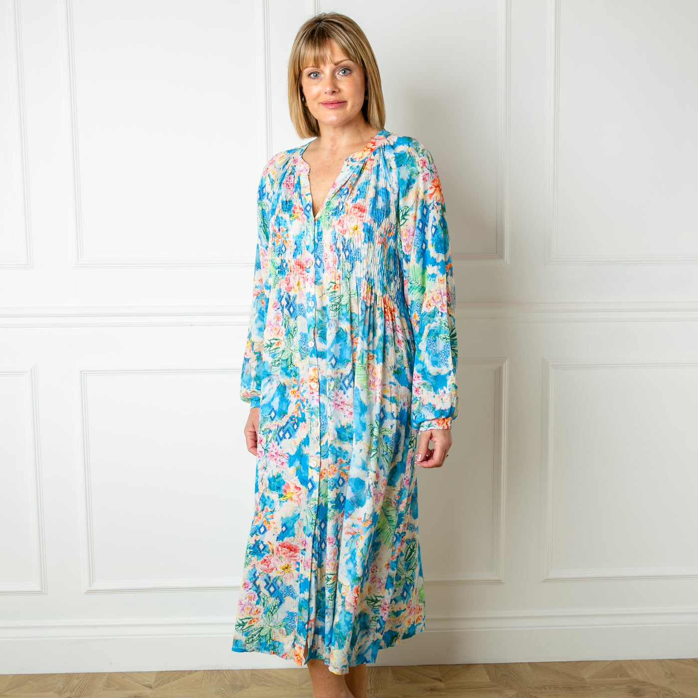 The blue Wild Garden Maxi Dress with long balloon sleeves and a collarless v neckline